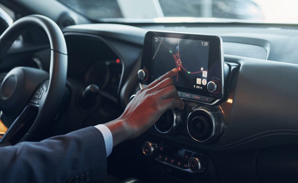 using-front-control-panel-young-african-american-businessman-in-black-suit-is-in-the-automobile-e1696325224629.jpg